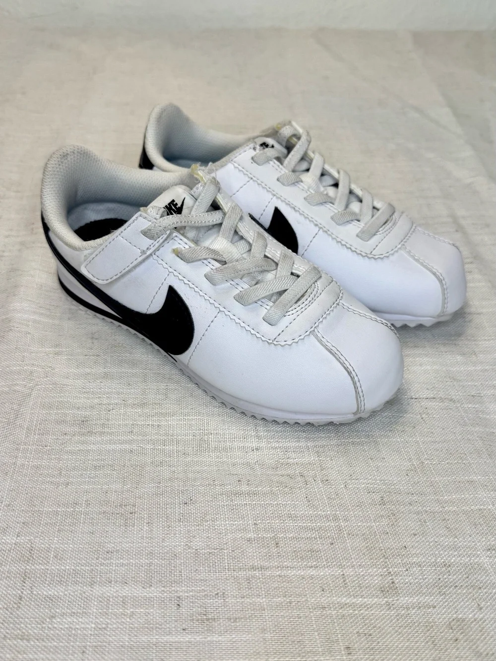 Nike Kids White Sneakers with Black Swoosh